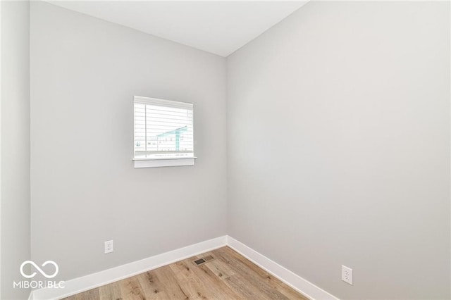 unfurnished room with visible vents, light wood-style floors, and baseboards