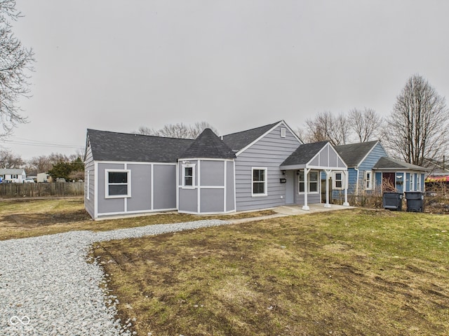 single story home with a front lawn and fence