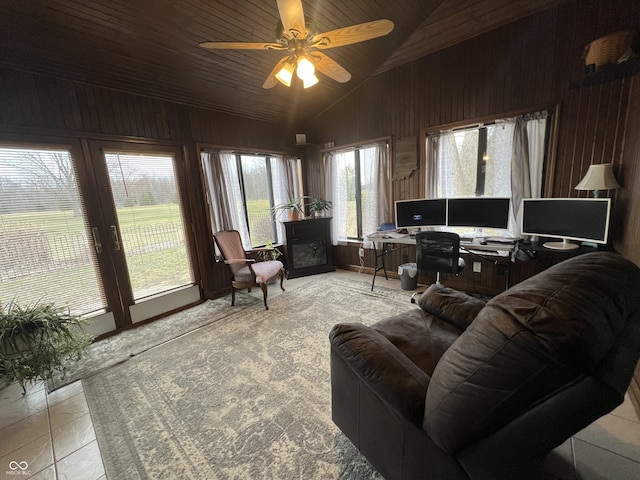 interior space featuring ceiling fan, high vaulted ceiling, wood ceiling, and wood walls