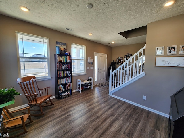 foyer with wood finished floors, visible vents, baseboards, recessed lighting, and stairs