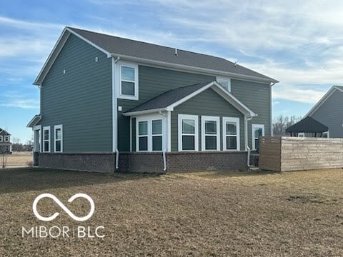 back of property featuring brick siding