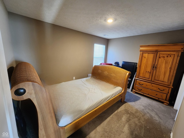 bedroom with a textured ceiling and carpet flooring