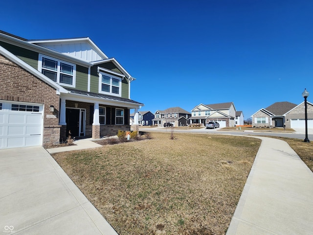 view of front facade featuring a front lawn, a residential view, board and batten siding, a garage, and brick siding