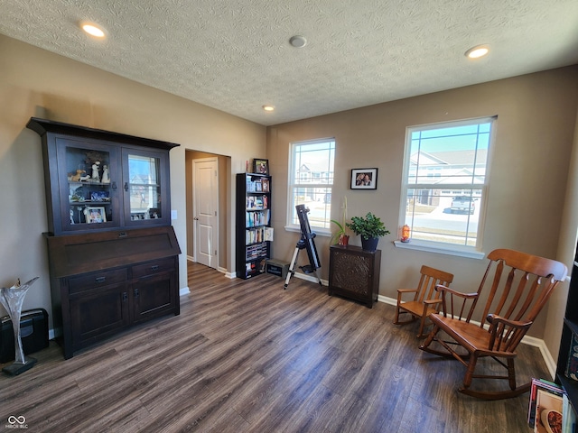 sitting room featuring recessed lighting, baseboards, dark wood-style flooring, and a textured ceiling