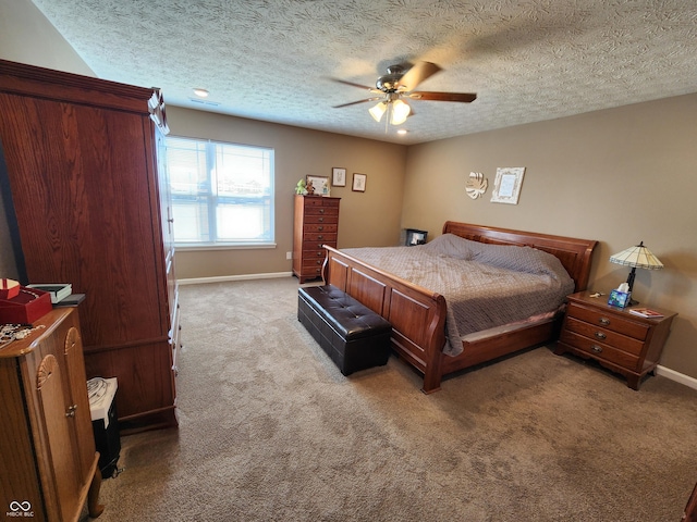 bedroom featuring a textured ceiling, carpet flooring, baseboards, and ceiling fan