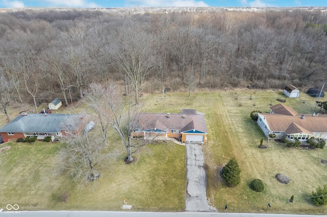 drone / aerial view featuring a wooded view