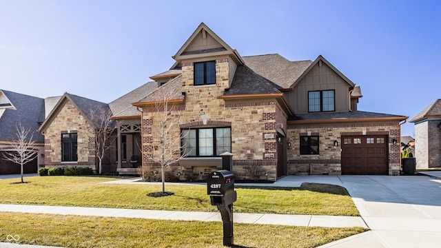 view of front of home with driveway, stone siding, board and batten siding, an attached garage, and a front yard