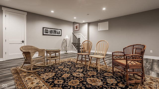 sitting room featuring stairway, recessed lighting, baseboards, and wood finished floors