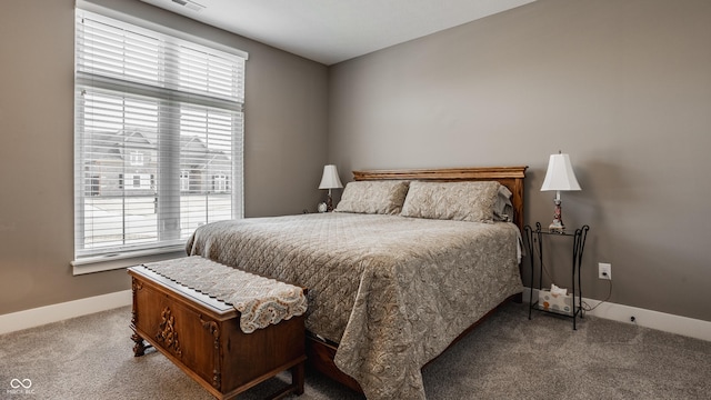 bedroom featuring multiple windows, carpet floors, and baseboards