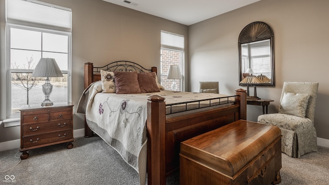 carpeted bedroom featuring visible vents and baseboards