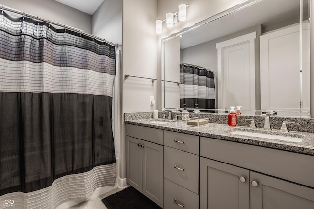 bathroom with double vanity, a shower with curtain, and a sink