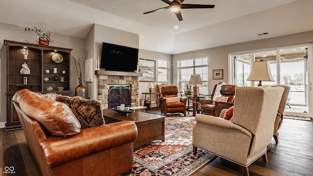 living room featuring ceiling fan, visible vents, dark wood-style floors, and a fireplace