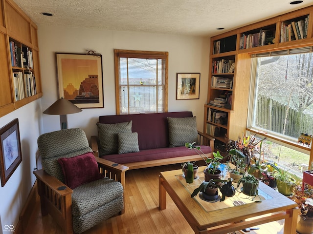 living room with wood finished floors and a textured ceiling