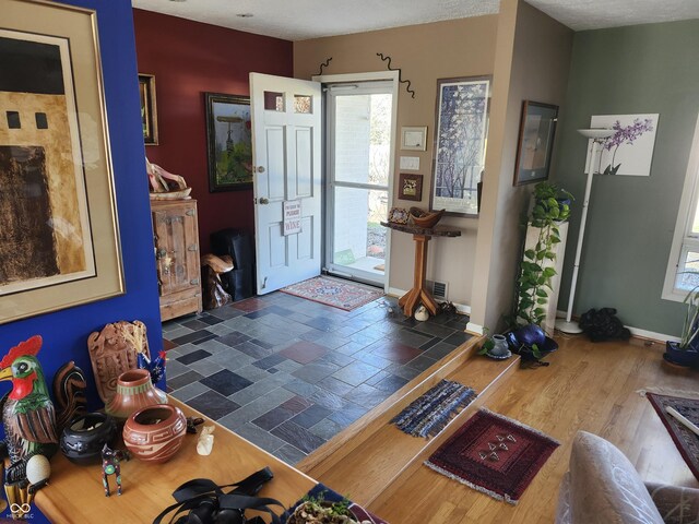 entrance foyer featuring baseboards and wood finished floors