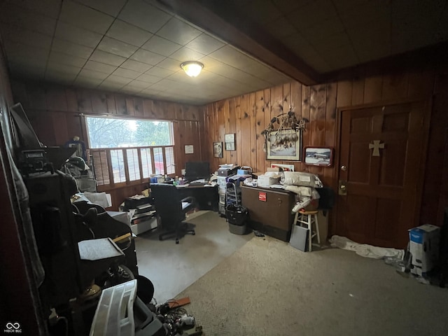 office area with beam ceiling, carpet, and wood walls