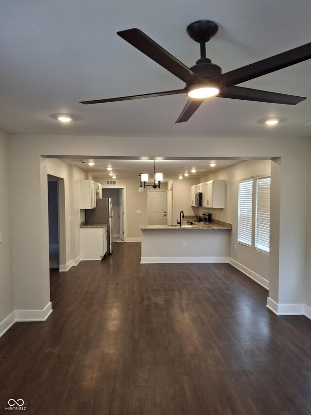 1974 Ralston Ave, Indianapolis, IN 46218 - unfurnished living room with dark wood-style flooring, ceiling fan, and recessed lighting