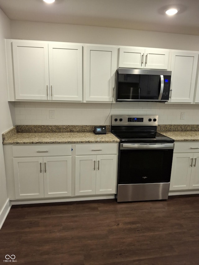 1974 Ralston Ave, Indianapolis, IN 46218 - kitchen featuring stainless steel appliances, decorative backsplash, white cabinets, and recessed lighting