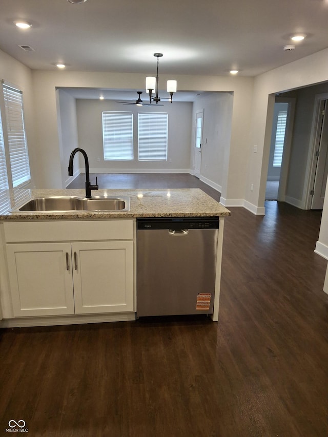 1974 Ralston Ave, Indianapolis, IN 46218 - kitchen with stainless steel dishwasher, light stone countertops, dark wood-style flooring, white cabinetry, and a chandelier