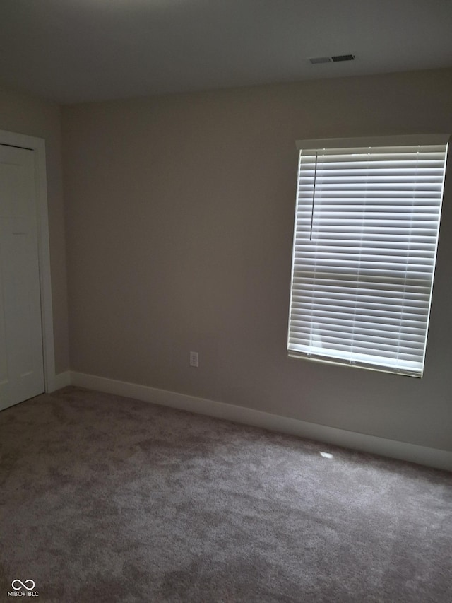 1974 Ralston Ave, Indianapolis, IN 46218 - carpeted empty room featuring baseboards