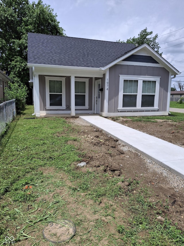 1974 Ralston Ave, Indianapolis, IN 46218 - single story home featuring a shingled roof, board and batten siding, and a porch