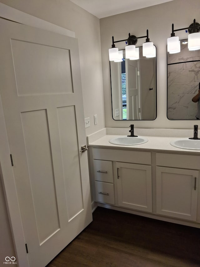 1974 Ralston Ave, Indianapolis, IN 46218 - full bathroom featuring double vanity and wood finished floors