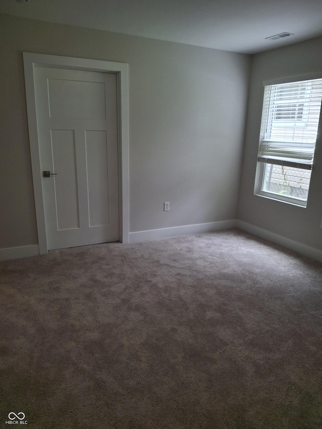 1974 Ralston Ave, Indianapolis, IN 46218 - carpeted spare room featuring baseboards