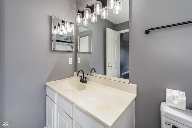 bathroom featuring toilet and vanity