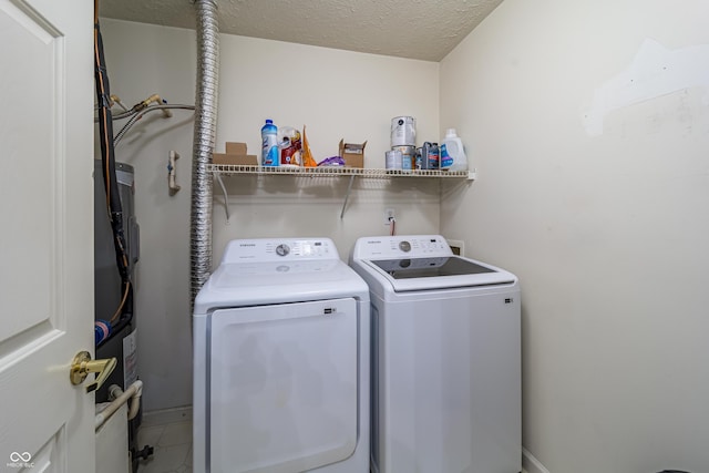 clothes washing area featuring laundry area, washer and dryer, and a textured ceiling