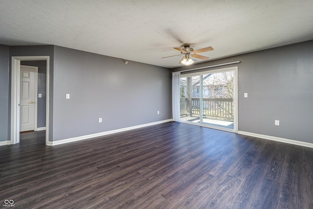 unfurnished room featuring baseboards, a textured ceiling, dark wood finished floors, and a ceiling fan