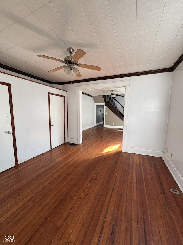 spare room with baseboards, wood-type flooring, ceiling fan, and crown molding