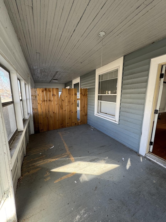 unfurnished sunroom featuring wood ceiling