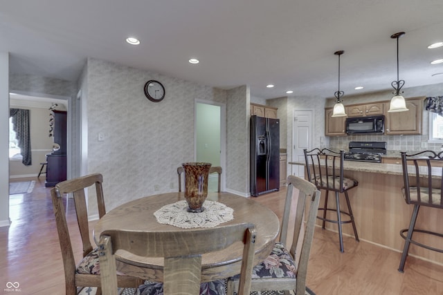 dining space featuring wallpapered walls, recessed lighting, baseboards, and light wood finished floors