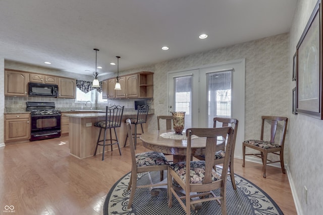 dining space with recessed lighting, baseboards, and light wood-style floors