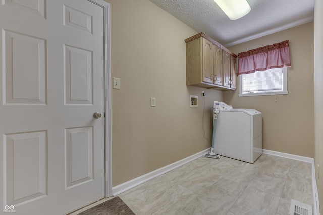 clothes washing area with visible vents, baseboards, washer / clothes dryer, cabinet space, and a textured ceiling