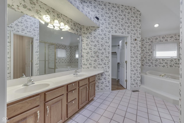 full bath featuring tile patterned flooring, wallpapered walls, and a sink