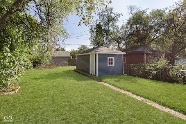 view of yard featuring an outdoor structure, a storage unit, and fence