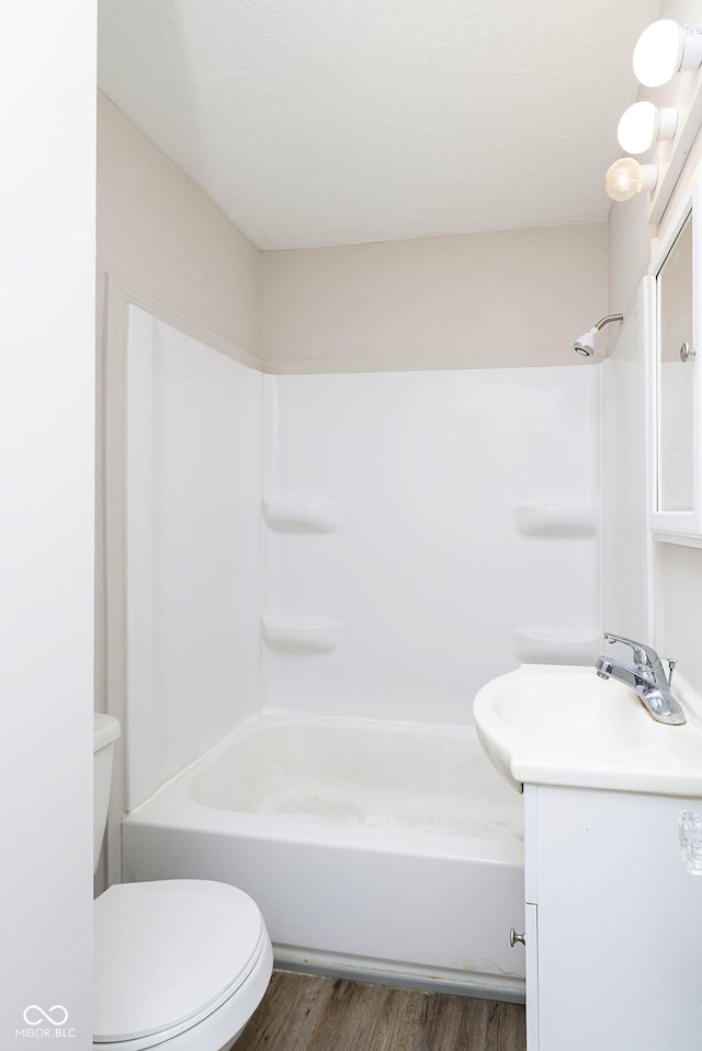 full bathroom featuring toilet, wood finished floors, and vanity