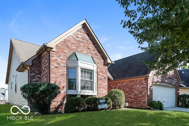 traditional-style home featuring driveway, brick siding, an attached garage, and a front lawn