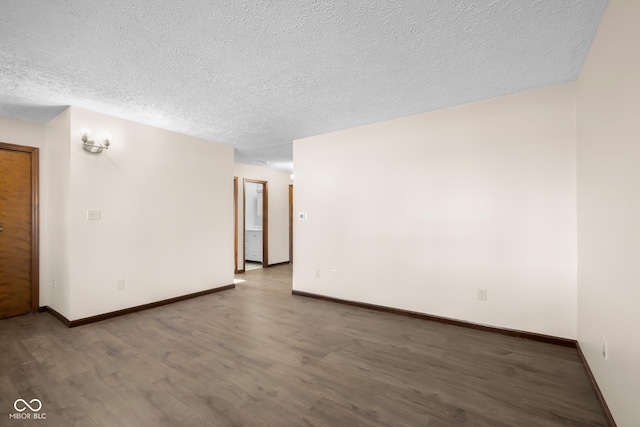 spare room with baseboards, a textured ceiling, and wood finished floors