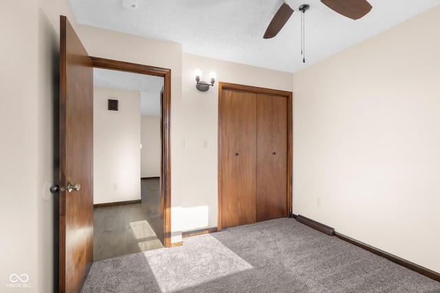 unfurnished bedroom with a ceiling fan, baseboards, a closet, a textured ceiling, and carpet flooring