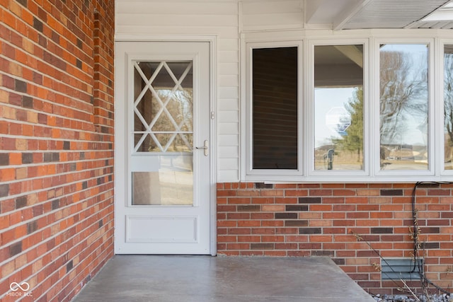 property entrance with brick siding