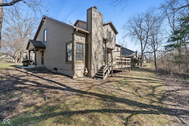 view of side of property with a deck and a chimney