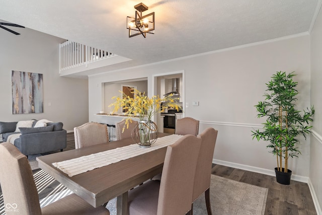 dining space featuring baseboards, ceiling fan with notable chandelier, dark wood-style flooring, and crown molding