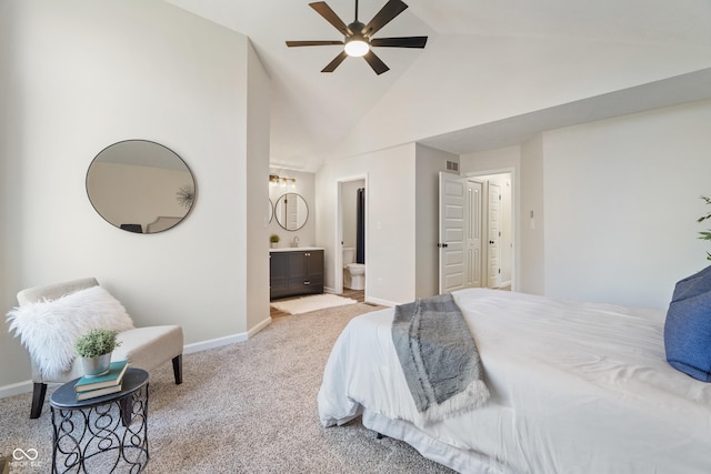 carpeted bedroom with visible vents, high vaulted ceiling, a sink, connected bathroom, and baseboards