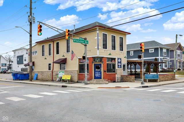 multi unit property featuring a residential view and brick siding