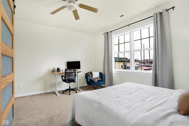 bedroom with visible vents, baseboards, ceiling fan, and carpet flooring