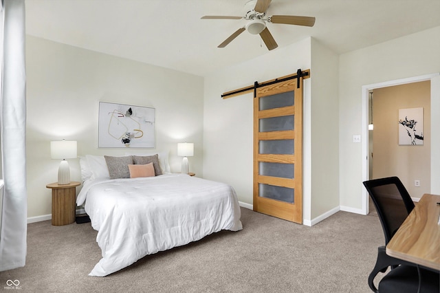 bedroom featuring ceiling fan, baseboards, carpet, and a barn door