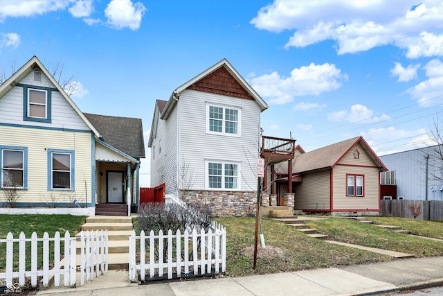 view of front of property featuring a fenced front yard and stone siding