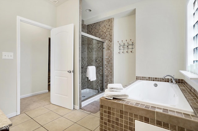 full bath with tile patterned flooring, a stall shower, a bath, and baseboards