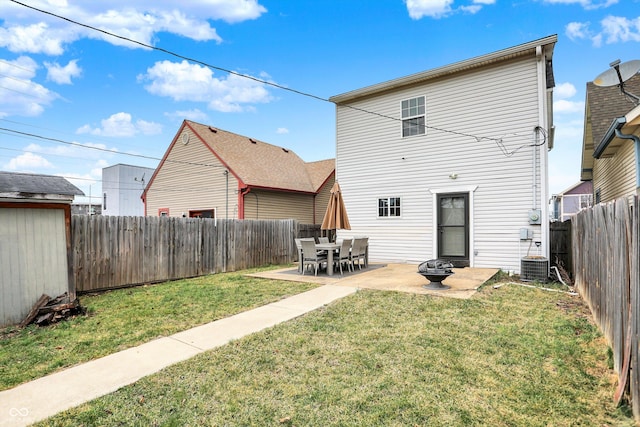 back of house featuring cooling unit, a yard, a patio, and a fenced backyard